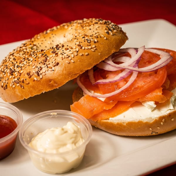 Everything bagel with cream cheese, smoked salmon, tomato, red onion, and two dipping sauces.